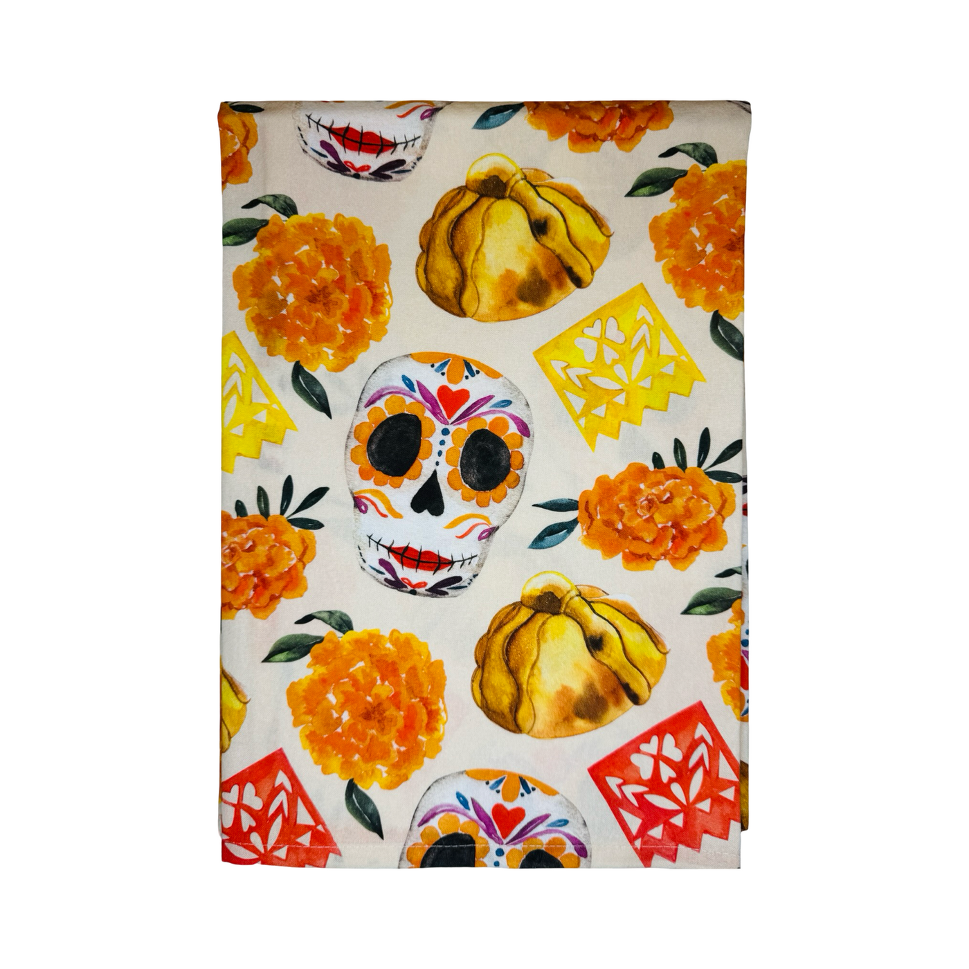 Kitchen towel decorated with marigolds, colorful sugar skulls, yellow and orange papel picado, and loaves of pan de muerto on a cream background.