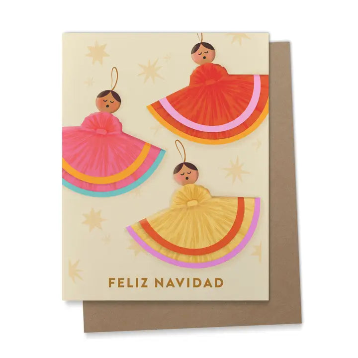 Greeting card with three angels in bright red, pink, and yellow dresses surrounded by golden stars, with the words “Feliz Navidad” in gold letters with a kraft envelope.