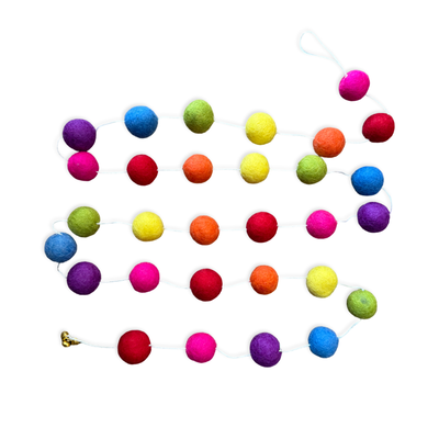 A string of colorful felt pom poms in rainbow hues arranged as a hanging garland against a white background.