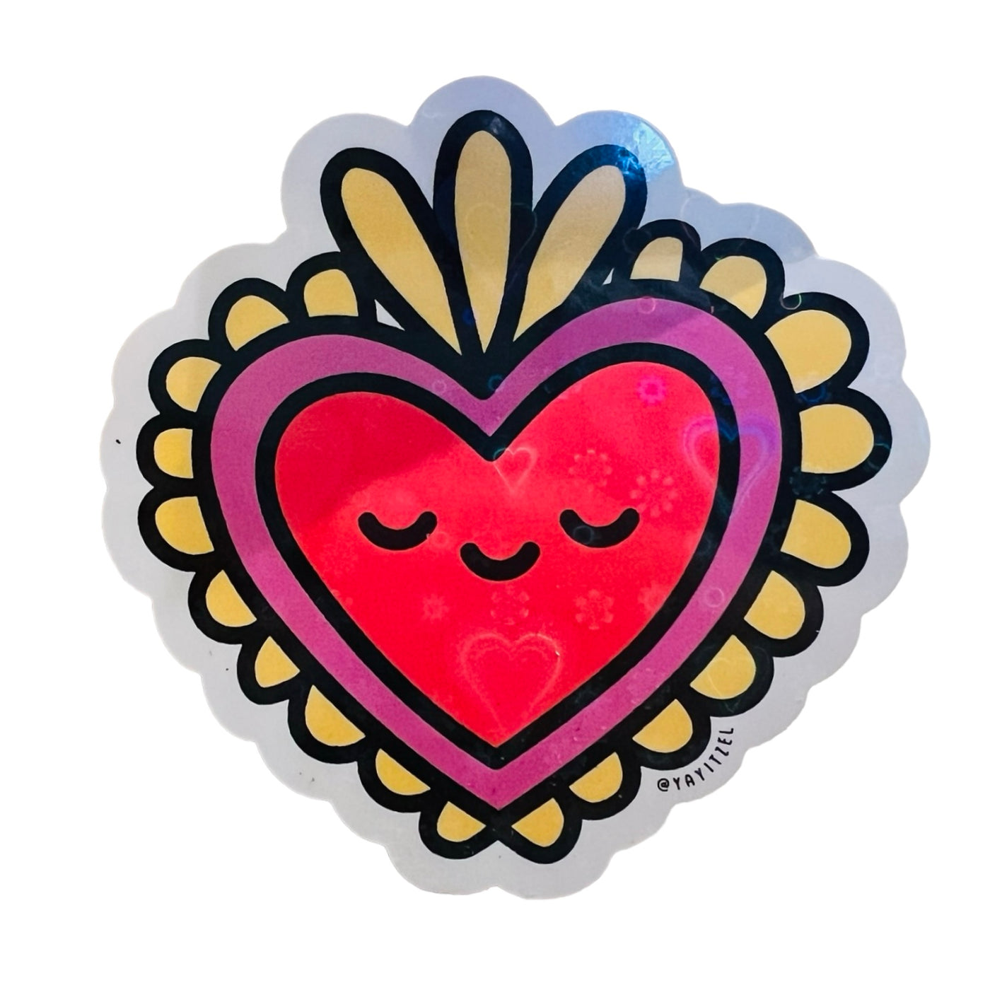 a red and gold sacred heart holographic sticker with a smiley face.