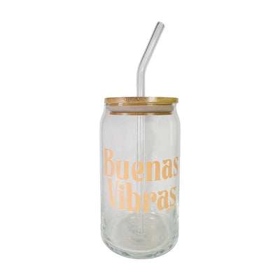 Clear can glass with the phrase Buenas Vibras in light orange lettering featuring a wooden lid and glass straw.