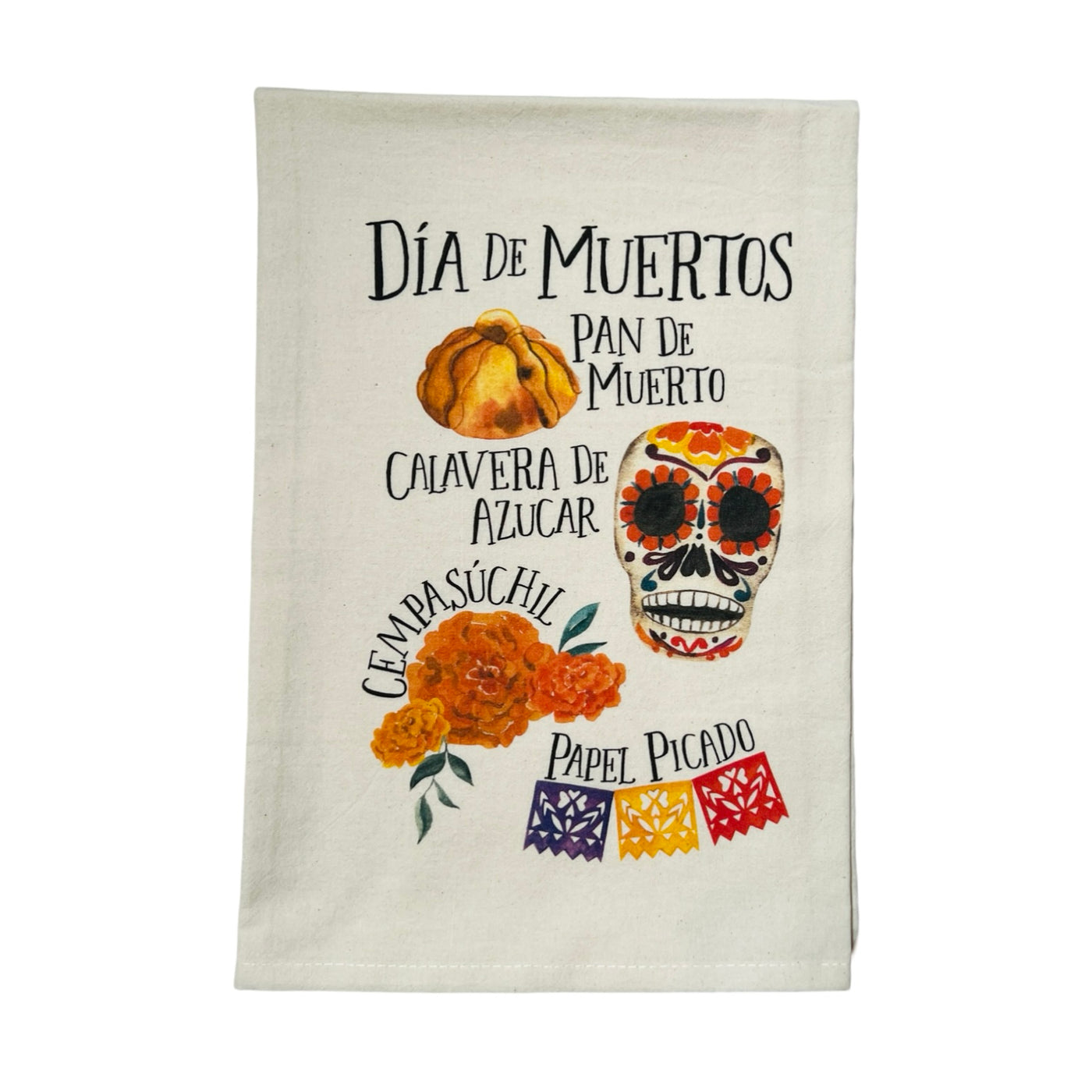 natural towel folded in half that features essential items of what are needed for an altar featuring images of a pan de muerto, sugar skull, marigold and papel picado