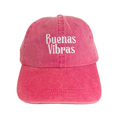 front view of a heathered red hat with the phrase Buenas Vibras in white lettering