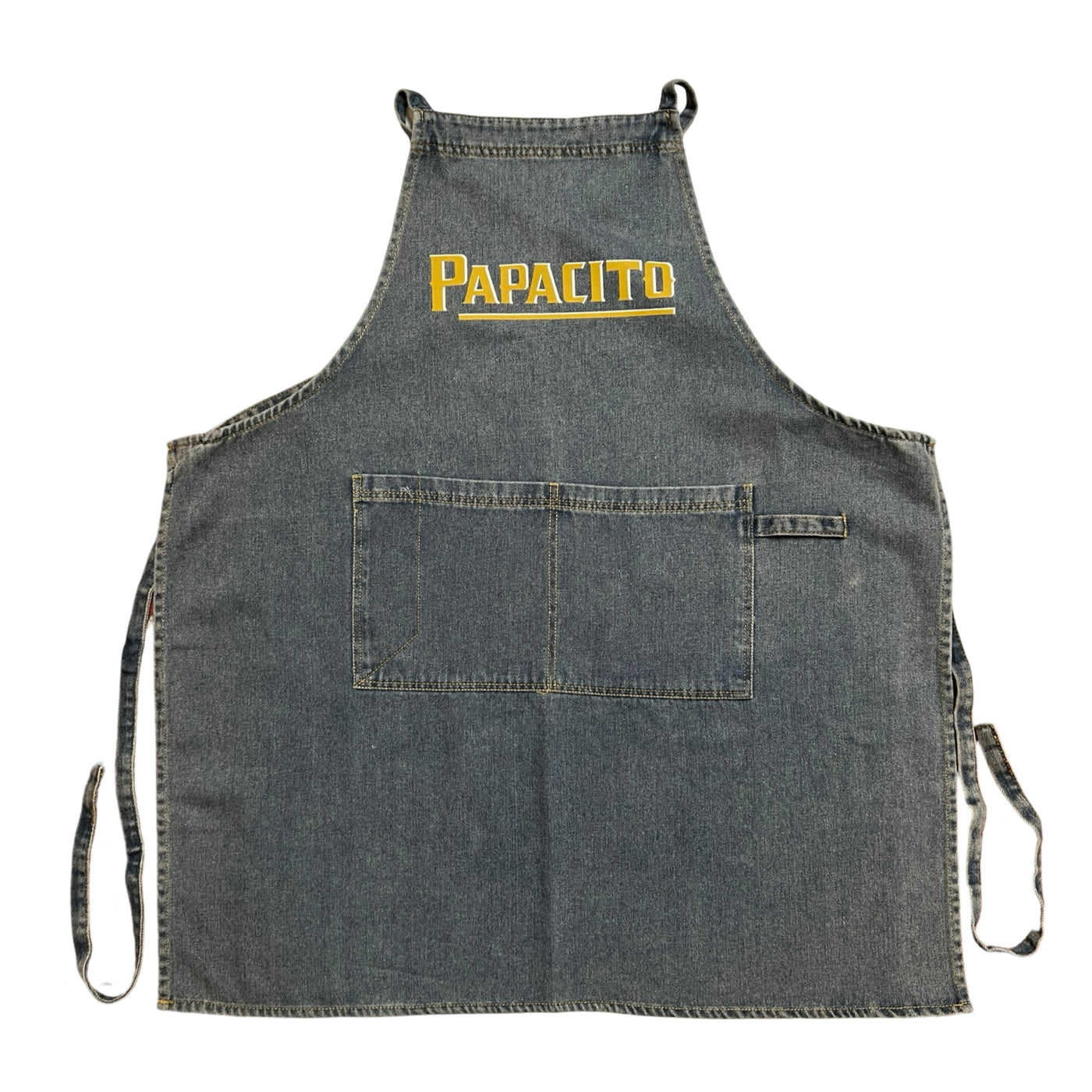 washed demin apron with the word papacito in yellow and white lettering