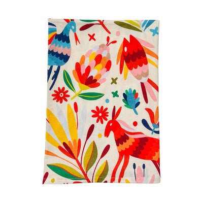 quarter folded cream kitchen towel with a mutli-colored otomi design