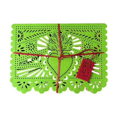 green felt papel picado inspired placemat that features a sacred heart design