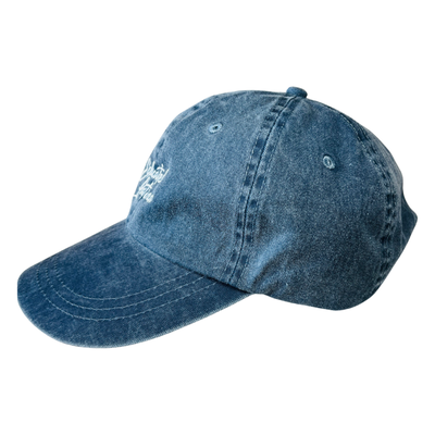 side view of a heathered blue hat with the phrase Educated Latina in white lettering