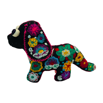 side view of a black felt dachshund dog doll with embroidered multi-colored floral design