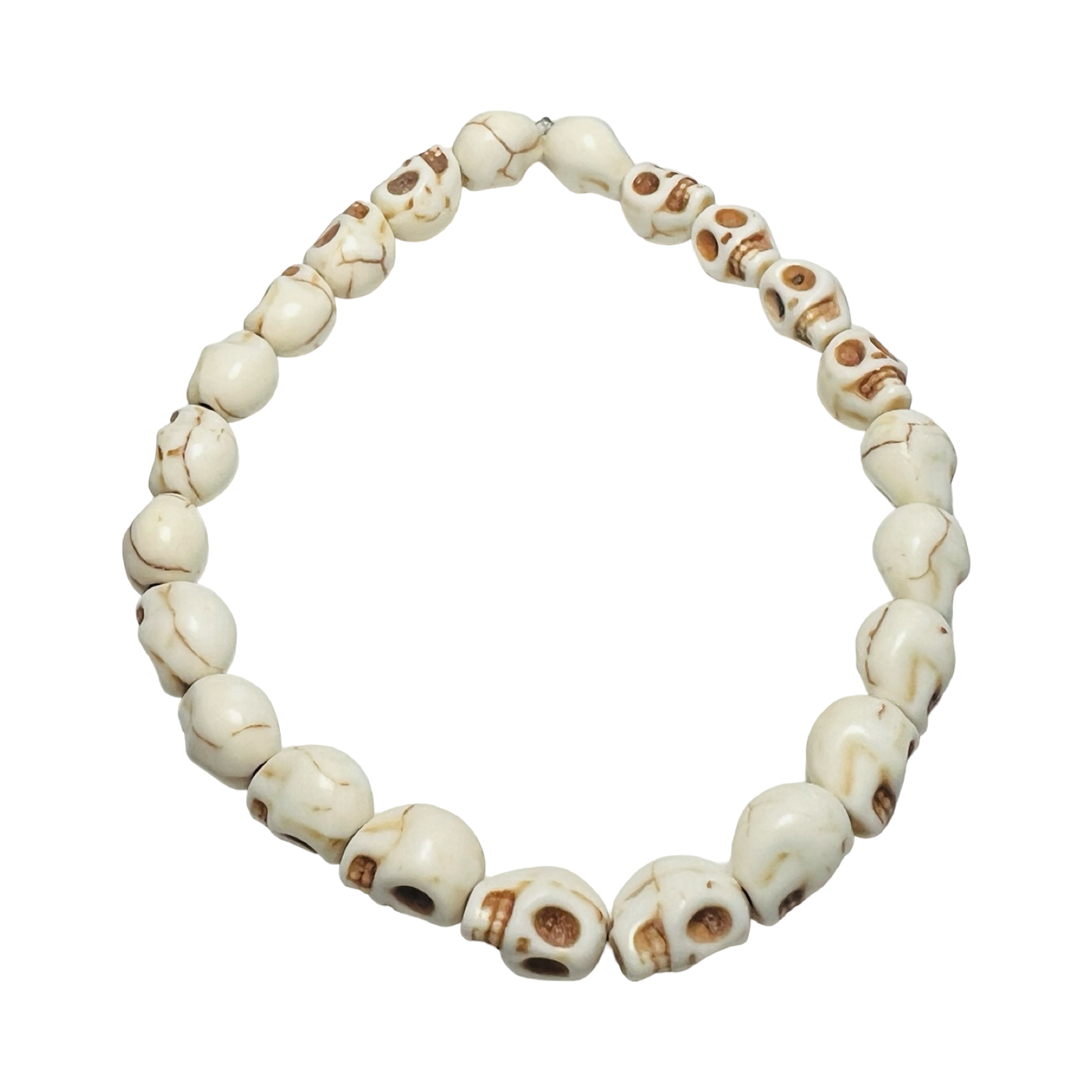 A Mexican Skull Bead Bracelet made of white, hand-carved skull-shaped beads, strung on an elastic band. 