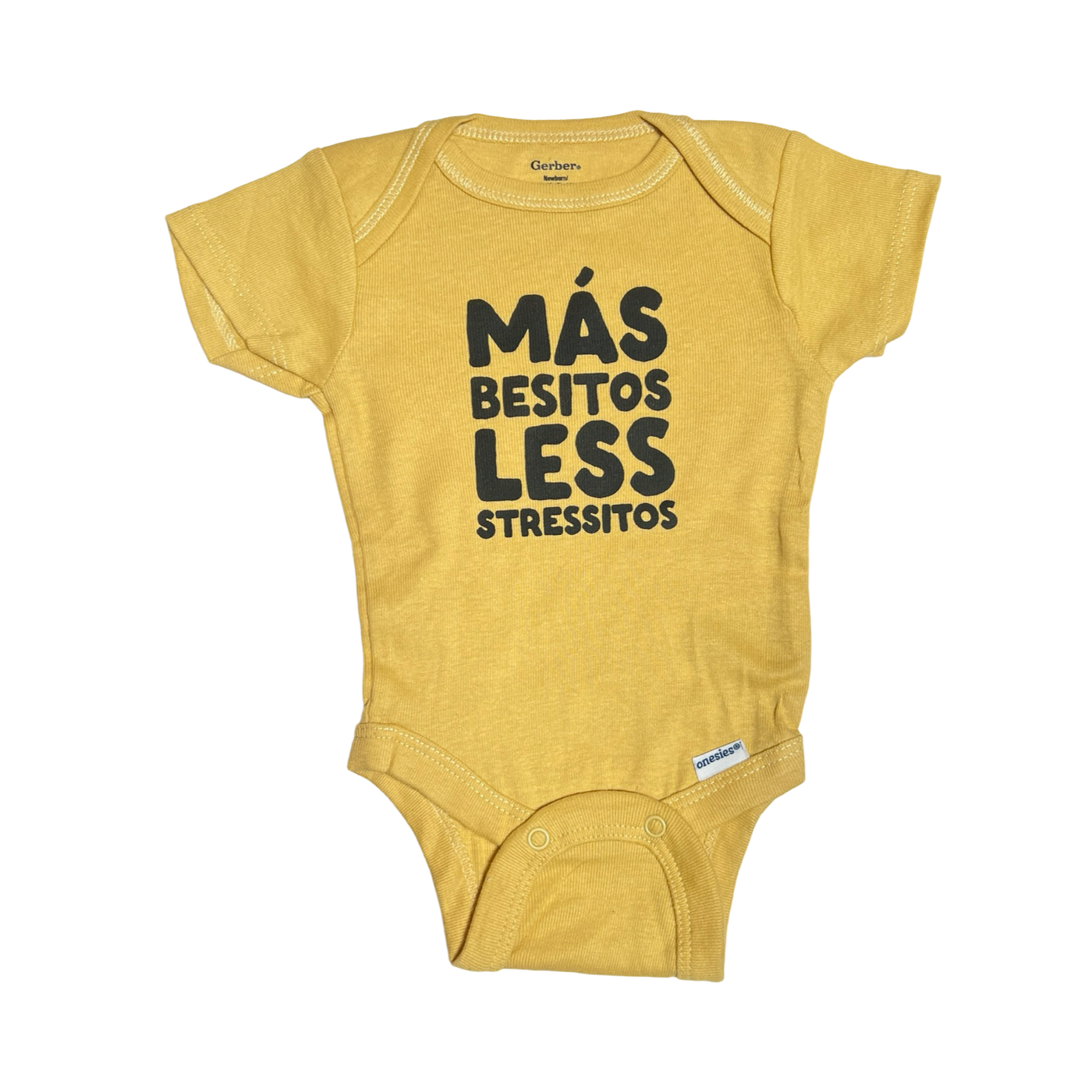 gold colored baby onesie featuring black text that reads "Más besitos less stressitos"