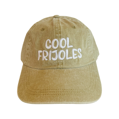 front view of a beige hat with the phrase cool frijoles in white lettering