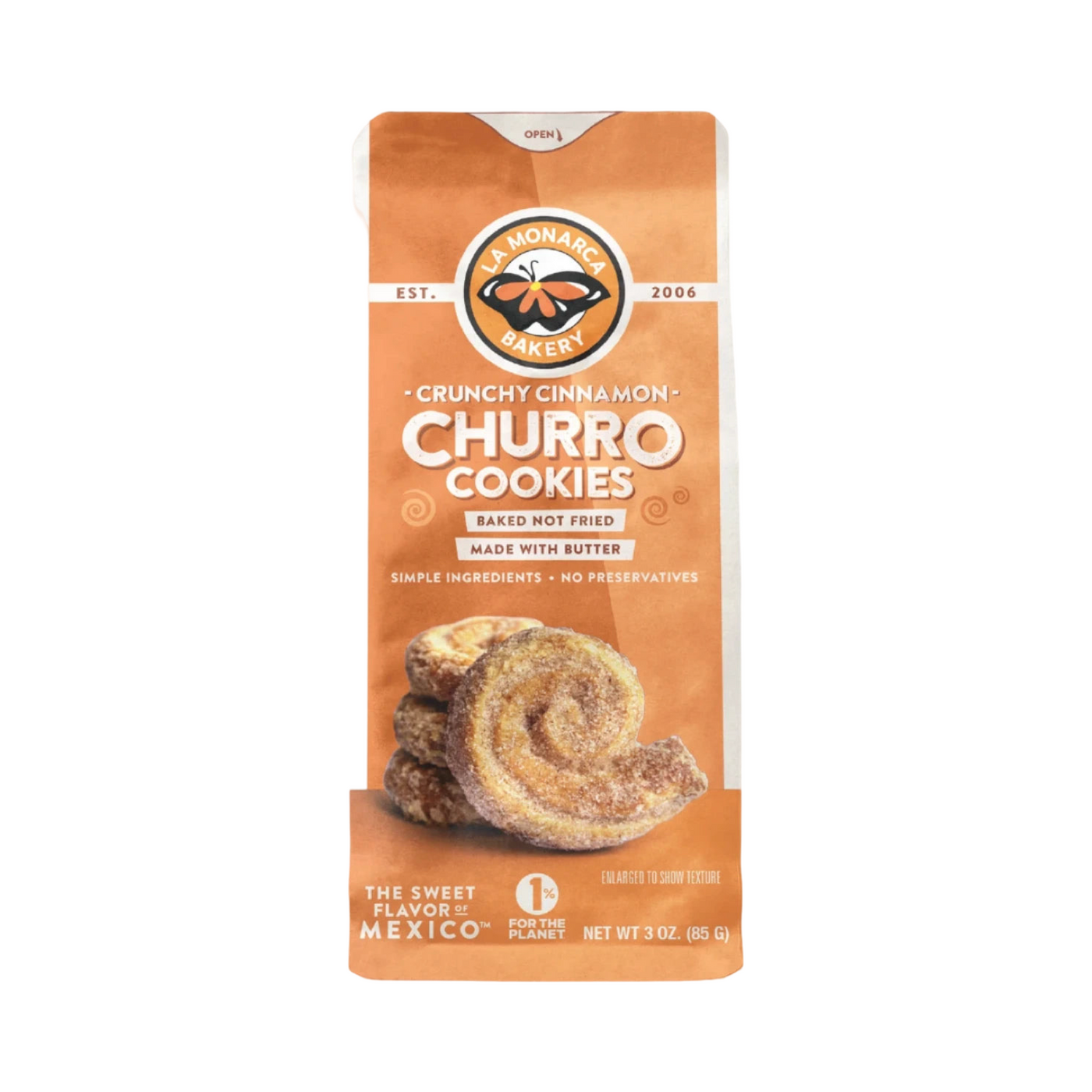 A bag of La Monarca Bakery Crunchy Cinnamon Churro Cookies, featuring warm orange packaging with the brand's logo at the top. The bag highlights key details, such as “baked not fried” and “made with butter.” The front showcases an image of the spiral-shaped cookies coated in cinnamon sugar, emphasizing their crisp texture. Net weight: 3 oz (85g).