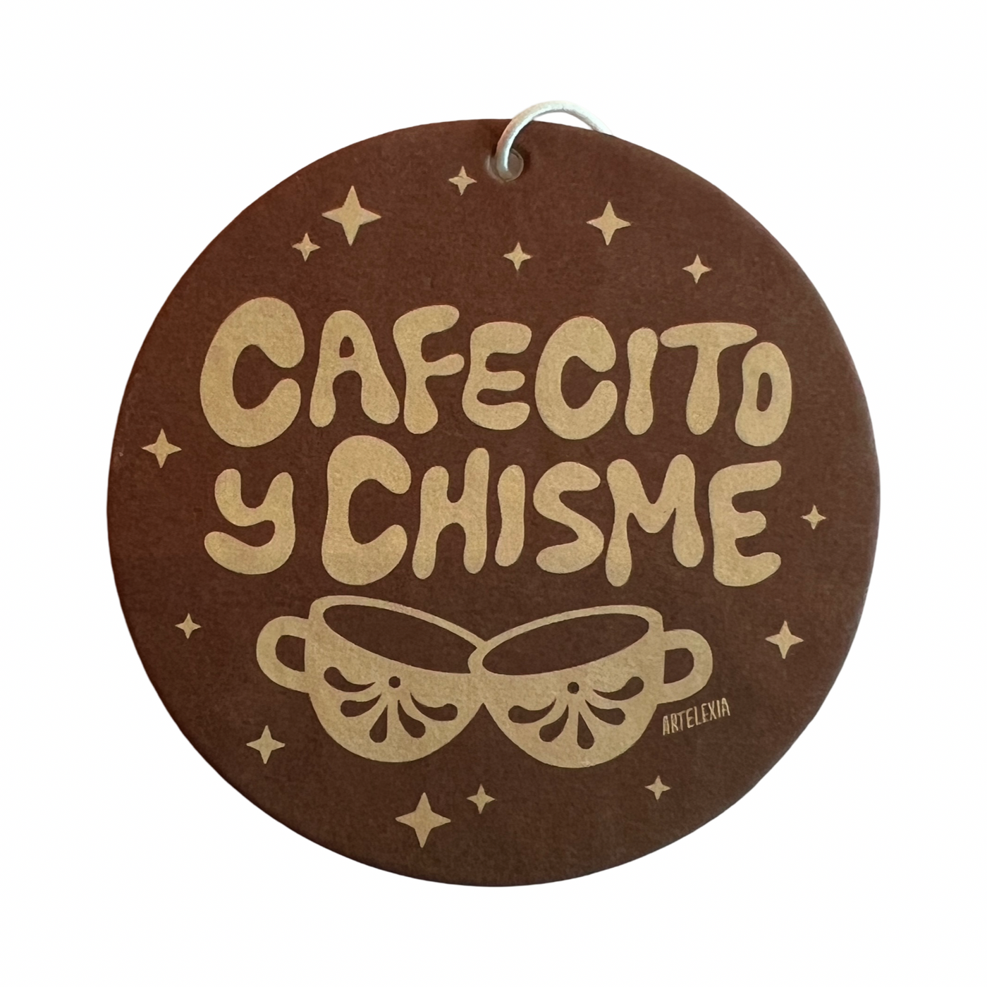 Round brown air freshener with the phrase Cafectio y Chisme in light brown lettering