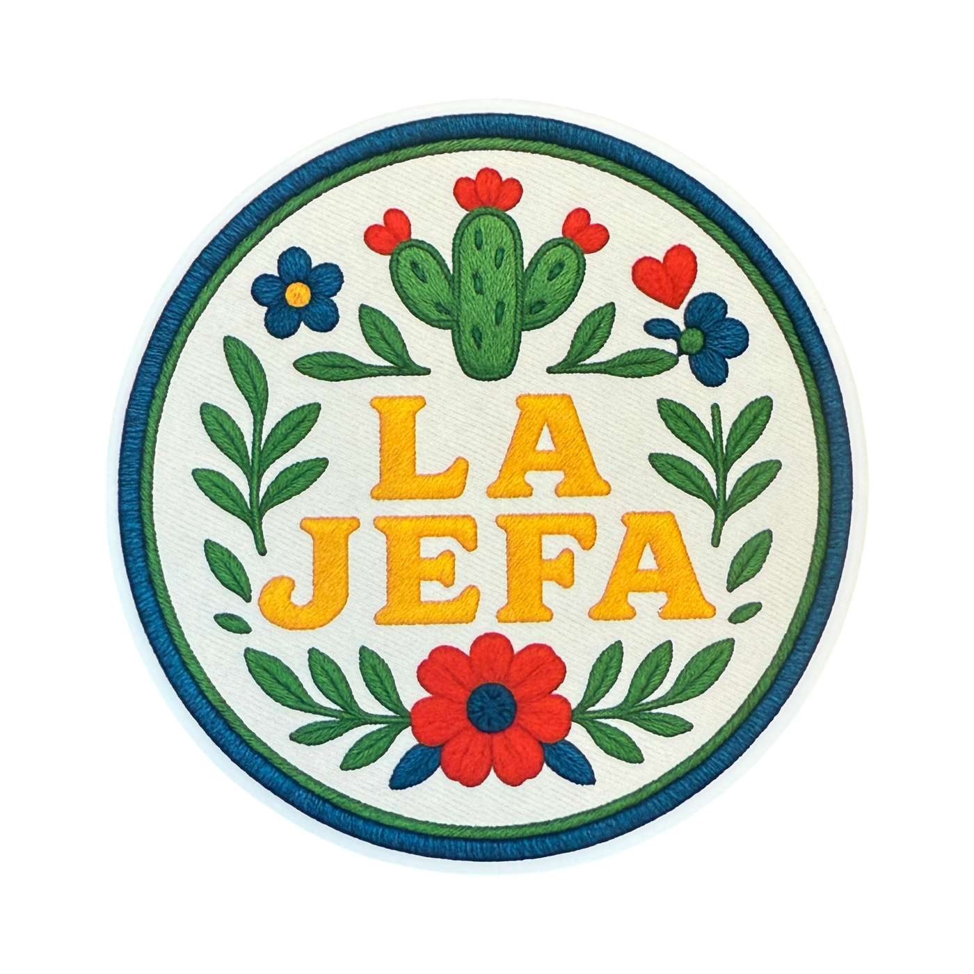 Round sticker with the phrase “La Jefa” in bold yellow letters, surrounded by floral and leafy designs with a nopal cactus at the top, all styled to resemble embroidery.