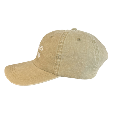 side view of a khaki hat with the phrase Buenas Vibras in white lettering