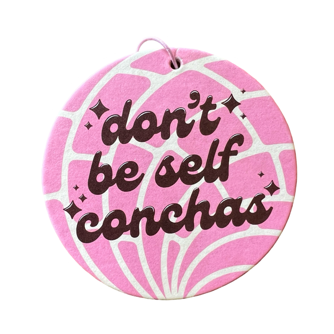 round concha shaped air freshener with the phrase Don't Be Self Conchas in brown lettering