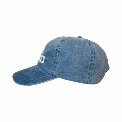 Side view of a blue hat with the phrase Cool Frijoles in white lettering