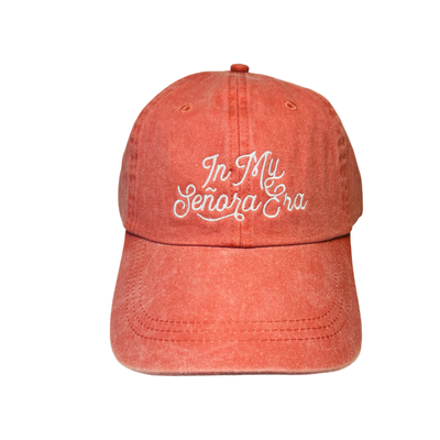 front view of a coral hat with the phrase In My Señora Era in white lettering