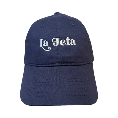 Front view of a navy blue hat with the phrase La Jefa in white lettering