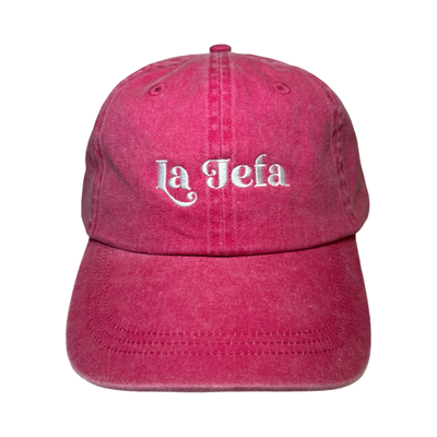 front view of a heathered red hat with the phrase La Jefa in White lettering