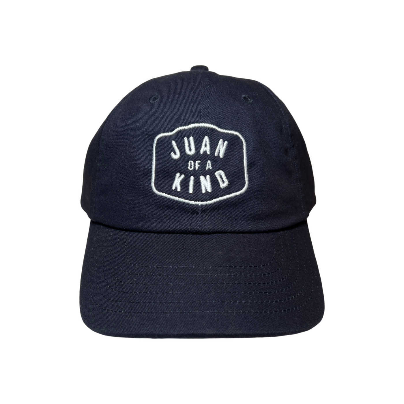 Front View of a navy blue hat with the Phrase Juan of a Kind in white letteing