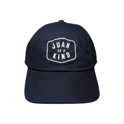 Front View of a navy blue hat with the Phrase Juan of a Kind in white letteing