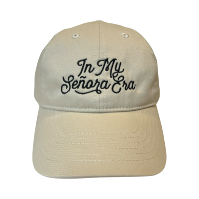 front view of a cream hat with the phrase In My Senora Era in black lettering