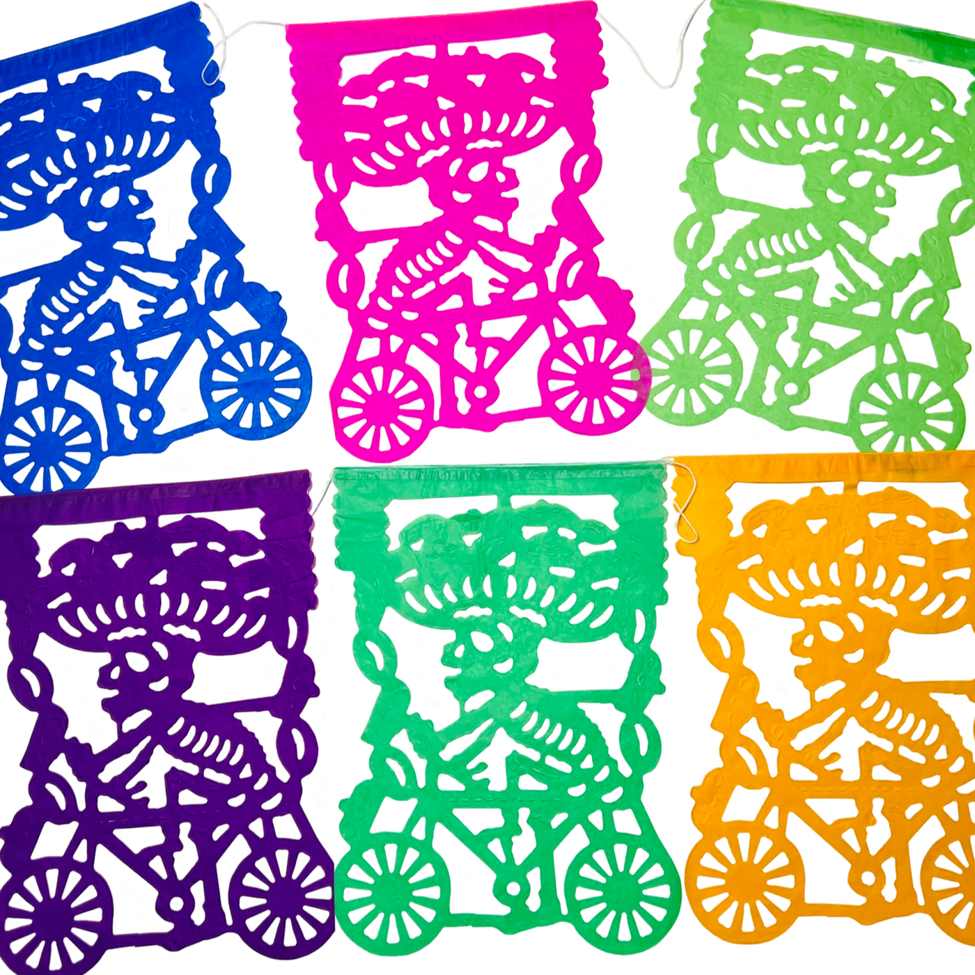 multicolor papel picado with design that features a skeleton riding a bike with a tray of bread on its head