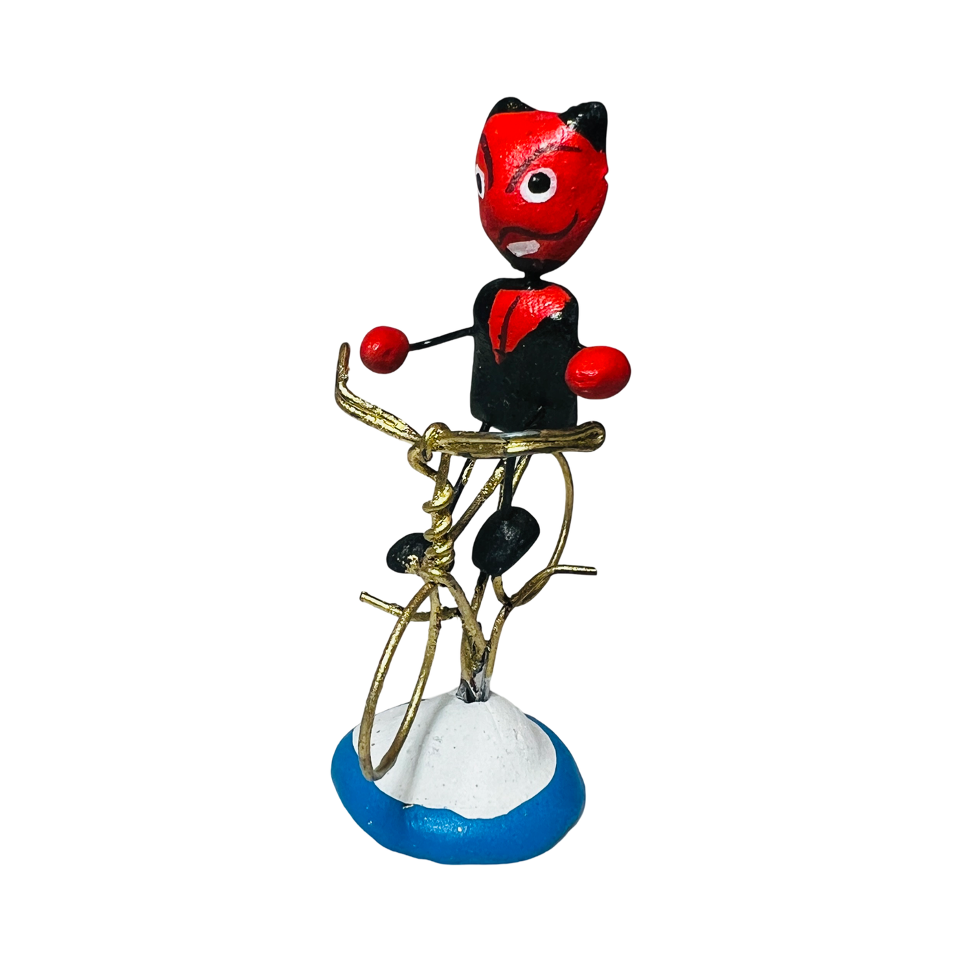 red diablito figurine in a tuxedo riding a bike