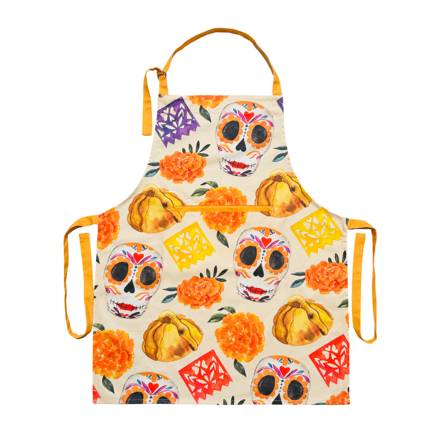 Cream apron printed with Día de Muertos motifs—sugar skulls, orange marigolds, pan de muerto, and yellow, orange, and purple papel picado—with a center pocket, adjustable neck strap, and yellow ties.