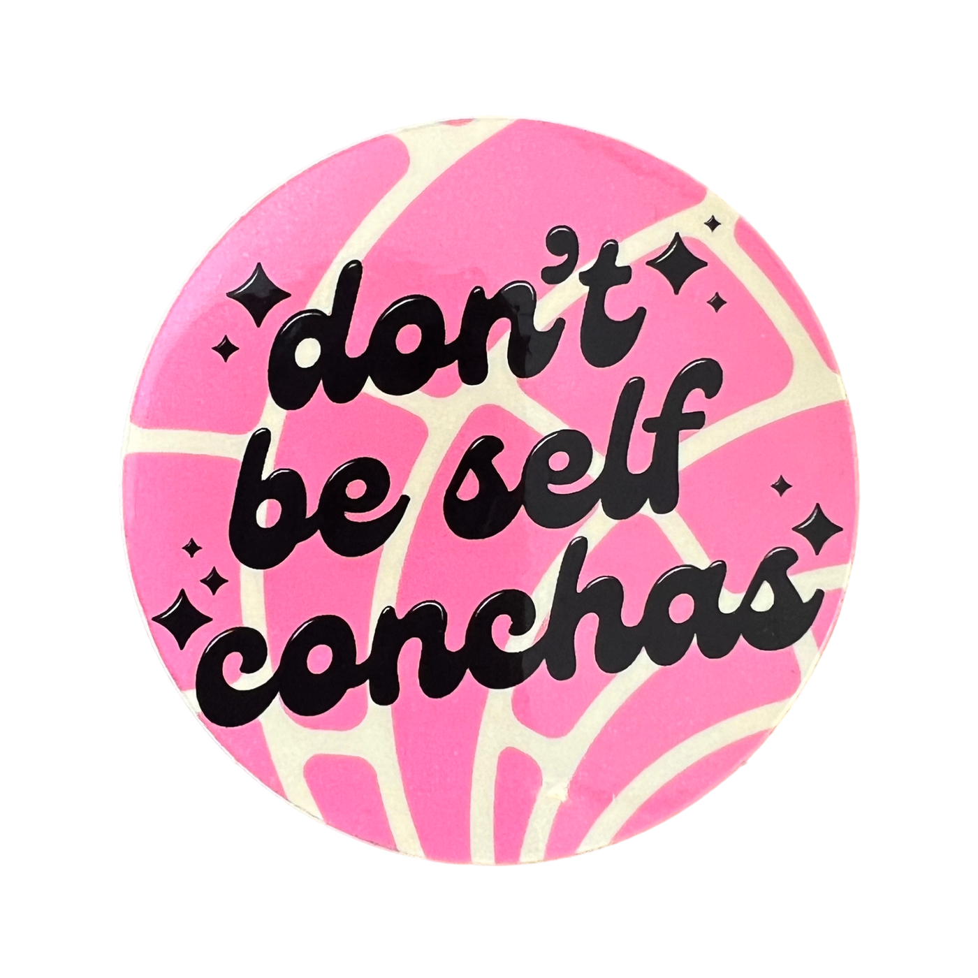 round sticker with a pink Mexican concha design featuring the phrase "Don't Be Self Conchas" in brown lettering.