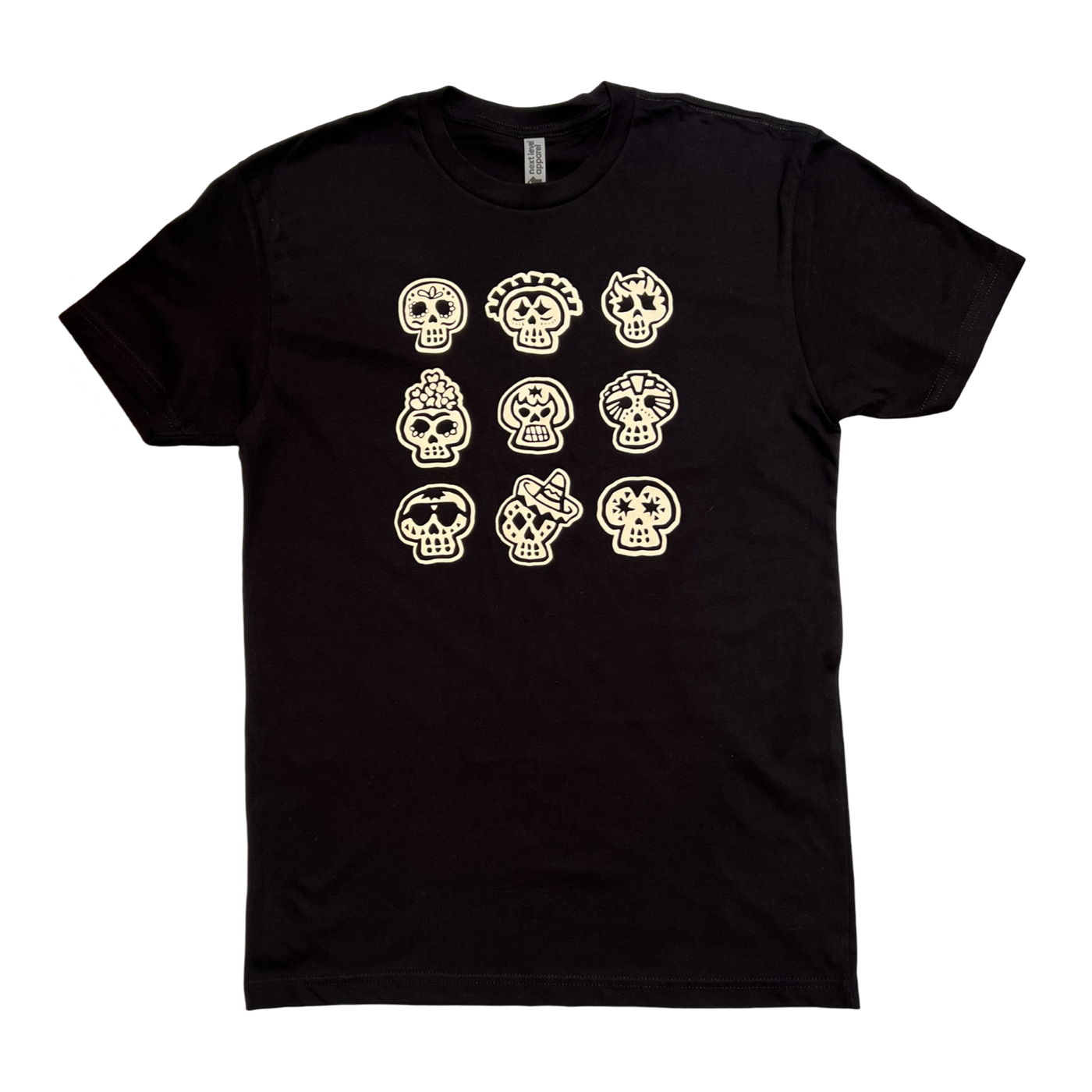 black shirt with nine images of various sugar skulls in a cream coloring.