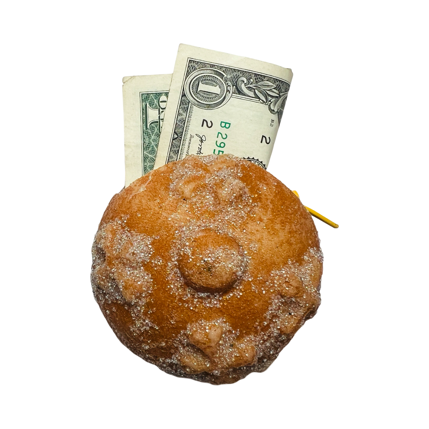 top view of a pan de muerto con pouch with a dollar sticking out of it