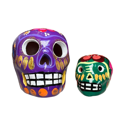 set of ceramic skulls with a colorful design painted on them