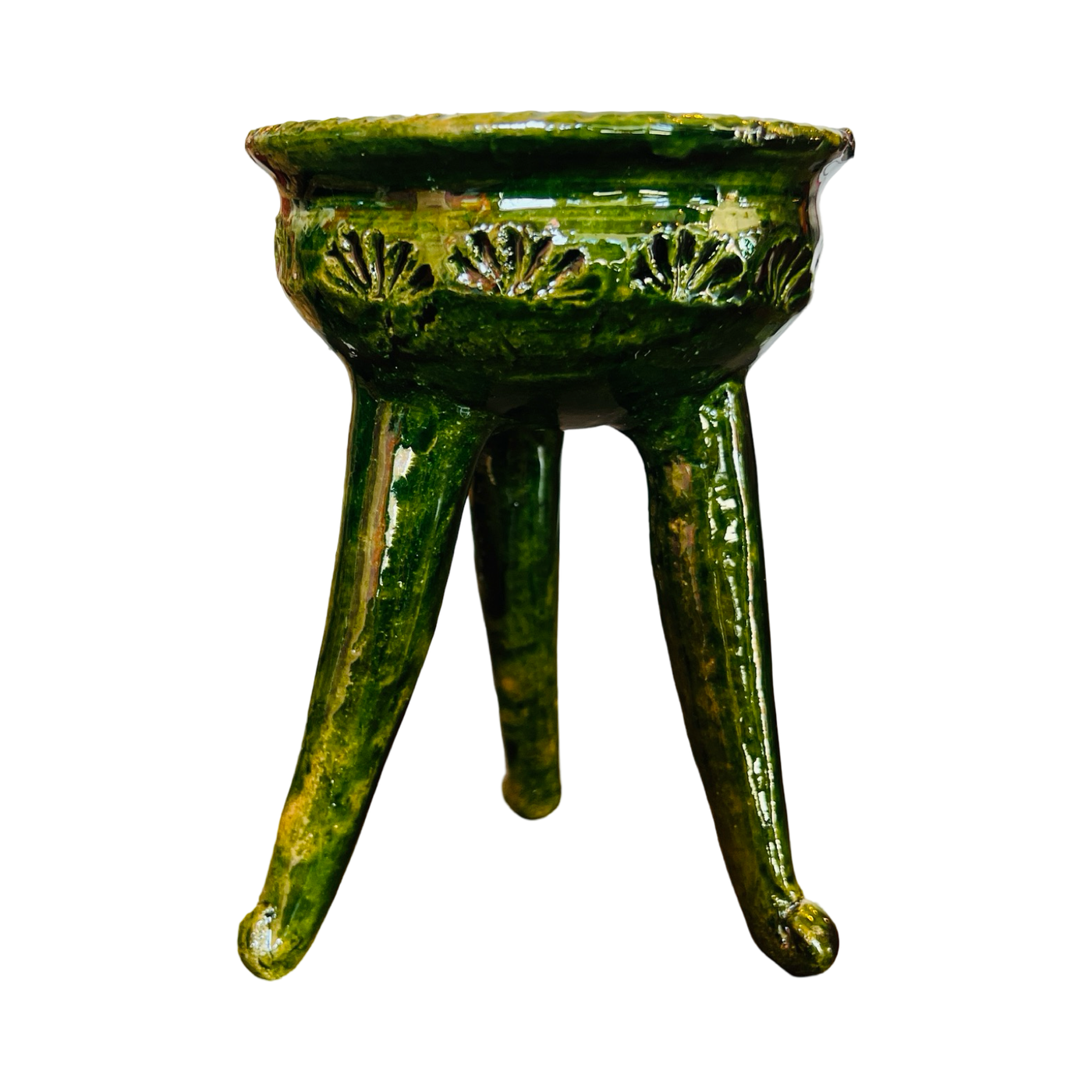 Side view of a three legged copalero, incense holder, with a green glaze.