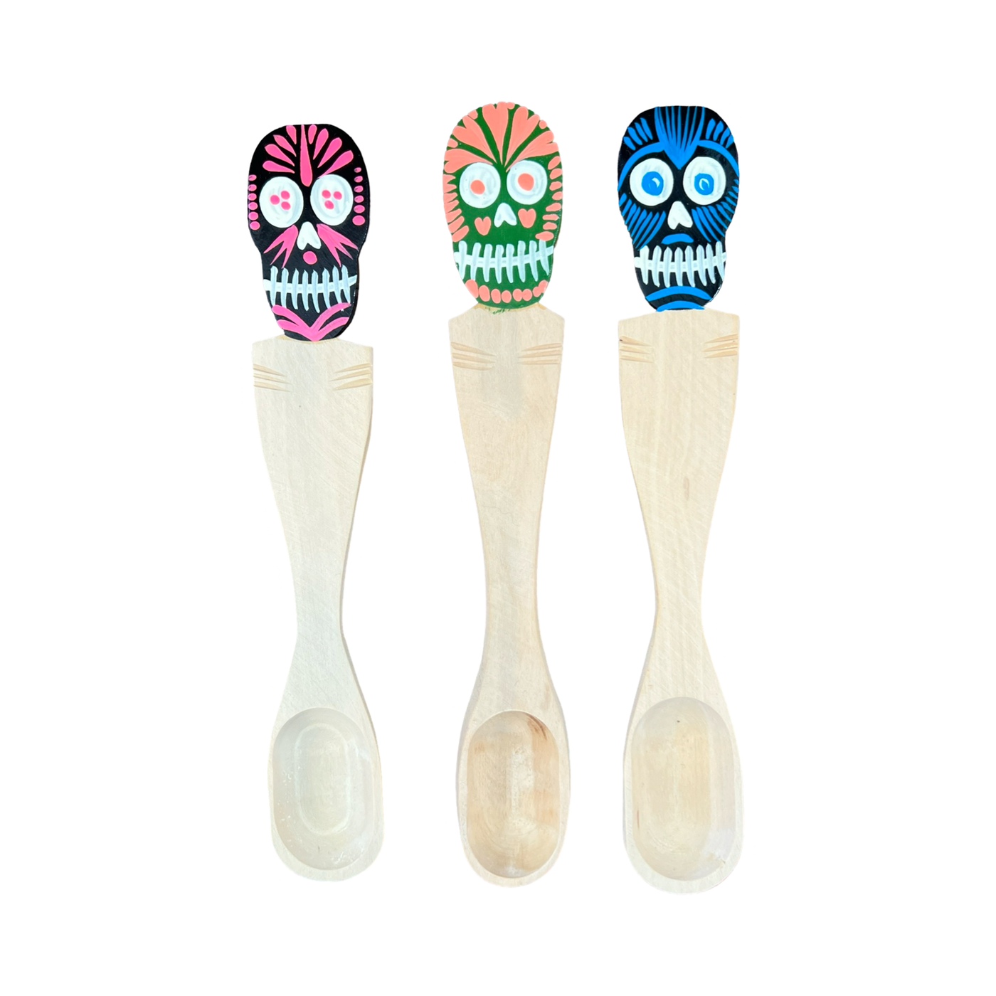 Three wooden spoons with multi-colored sugar skulls on the top of the handle