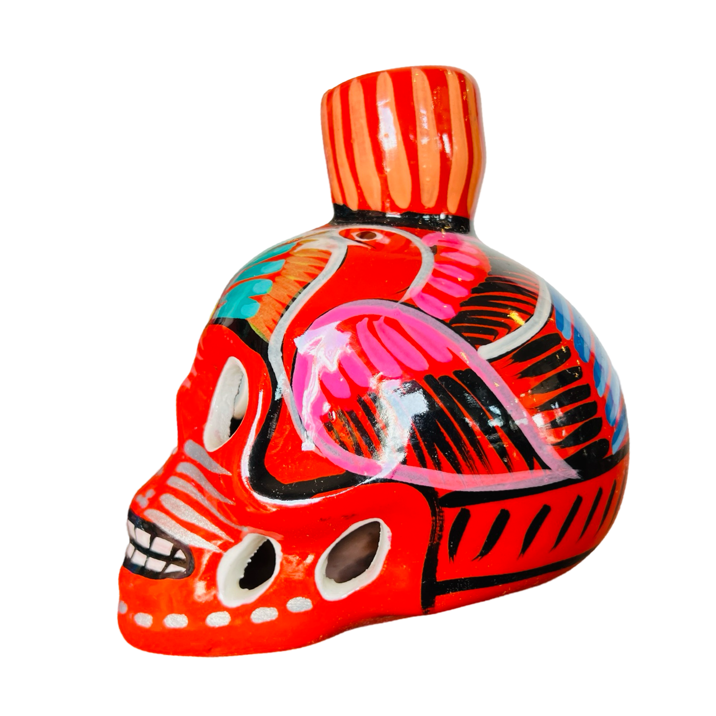 side view of a orange ceramic sugar skull candle holder with a multi-color floral design.