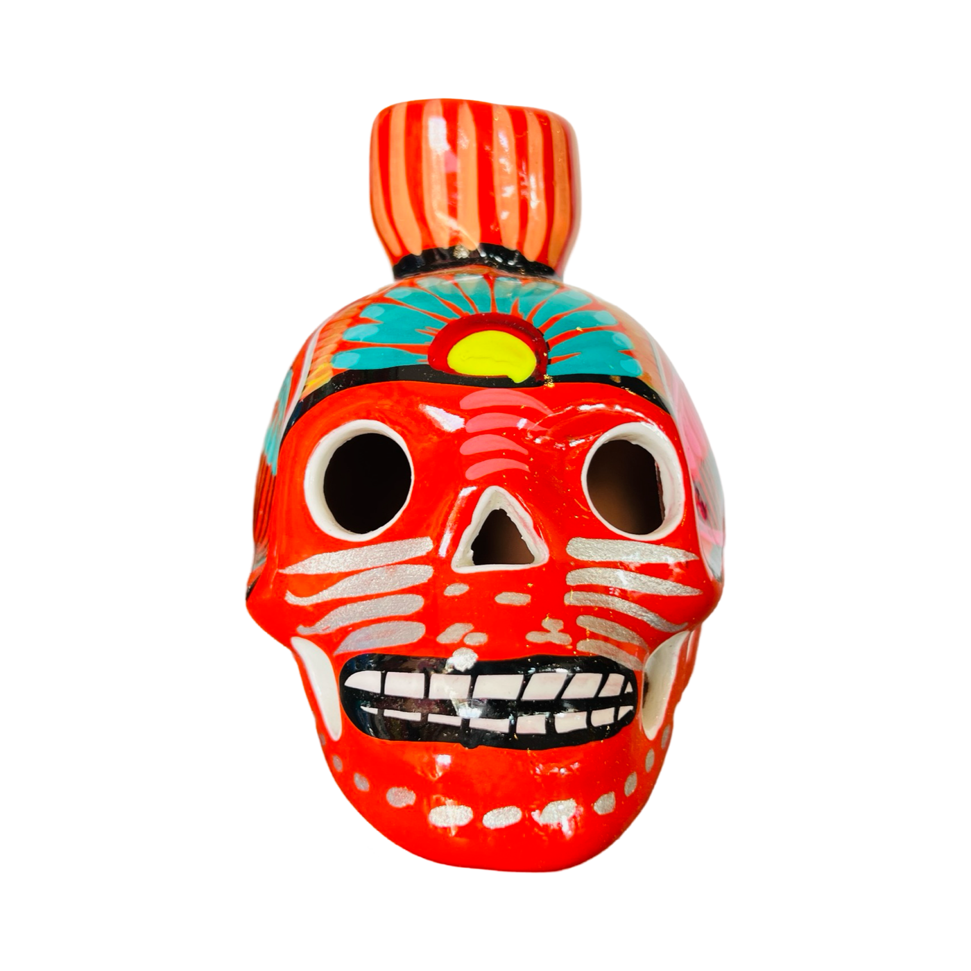 front view of a orange ceramic sugar skull candle holder with a multi-color floral design.