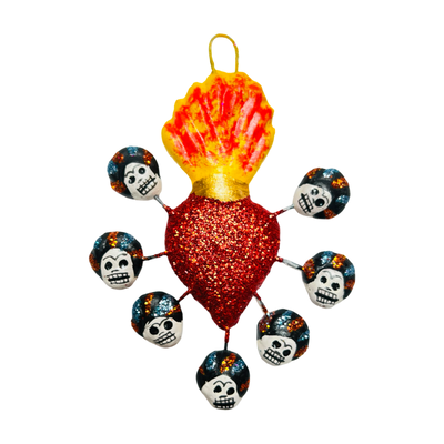 red glitter sacred heart with Frida calavera skulls surrounding it.