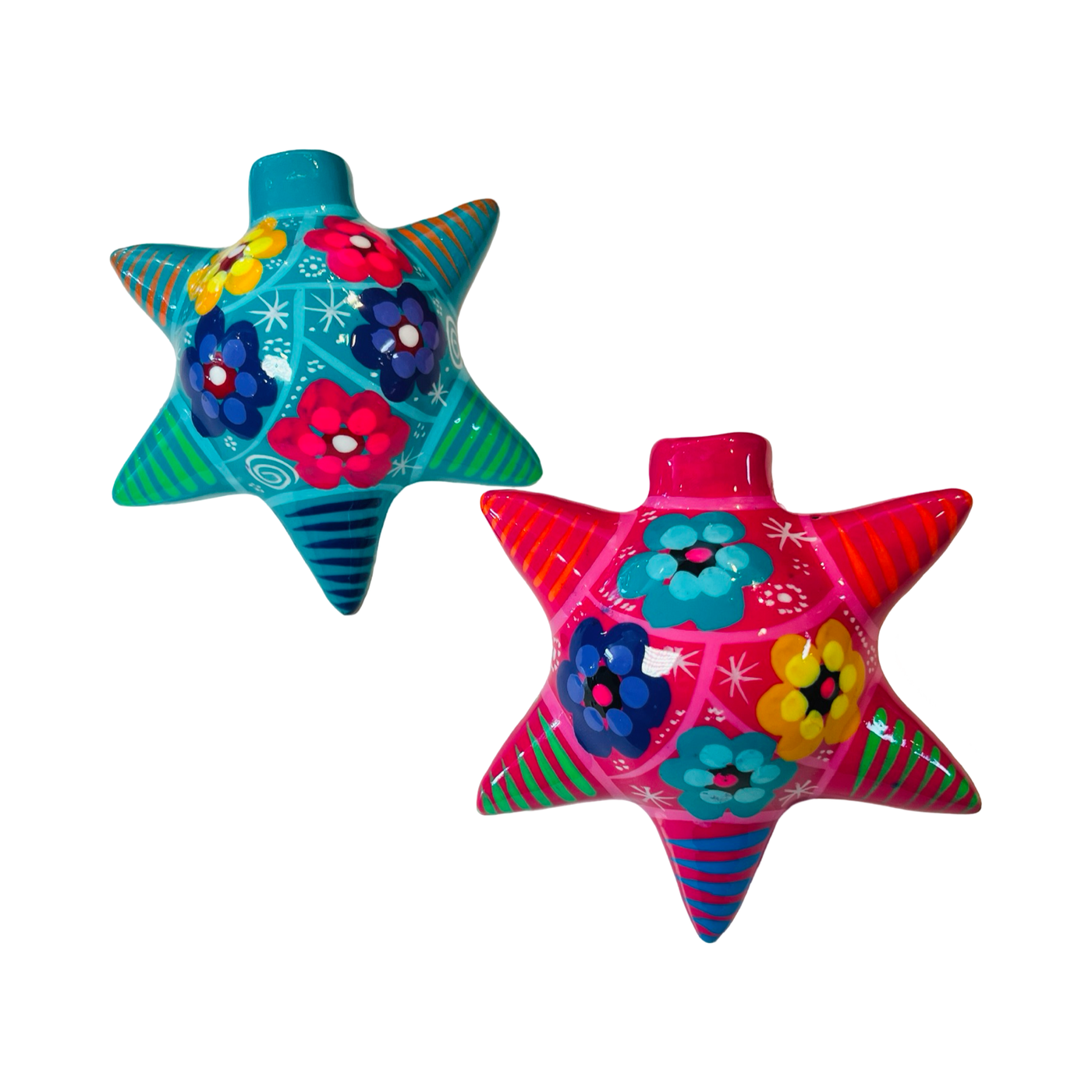 Two star-shaped ceramic piñata ornaments, hand-painted with colorful floral designs and striped patterns. One ornament features a turquoise base with red and yellow flowers, while the other showcases a pink base with blue and yellow flowers, embodying traditional festive artistry.