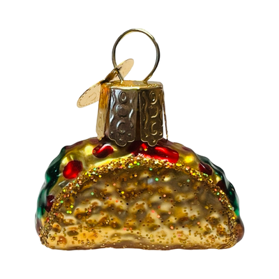 Mini glass taco ornament with detailed textures and glitter accents, featuring lettuce, tomato, and cheese toppings