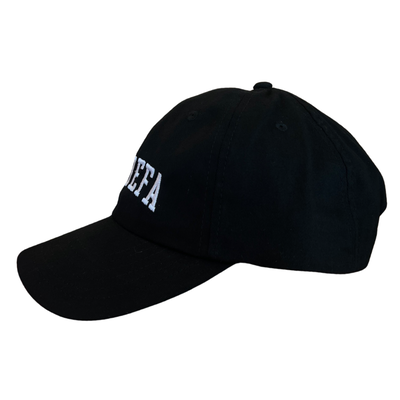 side view of a black hat with the phrase La Jefa in white lettering