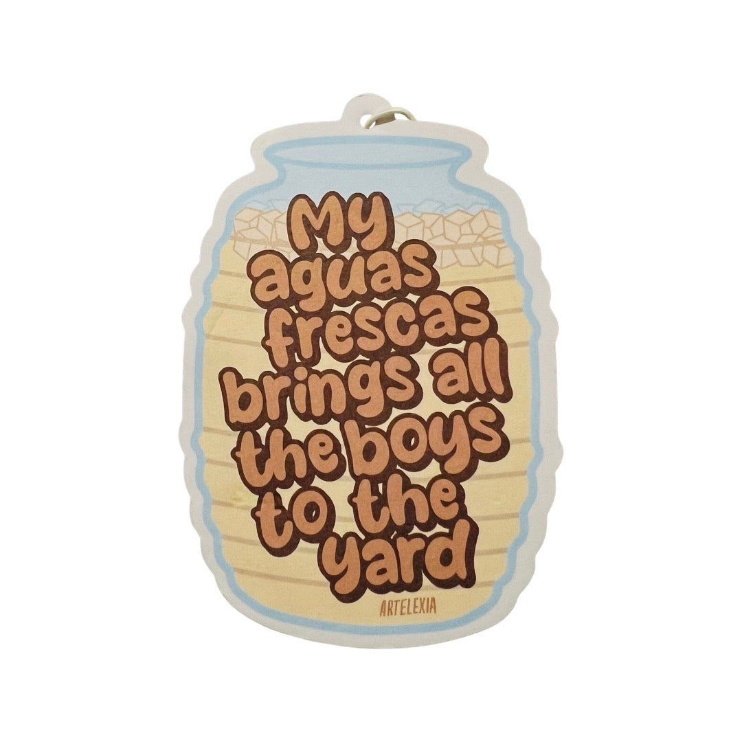 air freshener in the shape of an agua frescas container and the phrase My Aguas Frescas Brings All The Boys To The Yard in brown lettering.