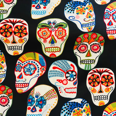 black fabric with images of coloful skulls