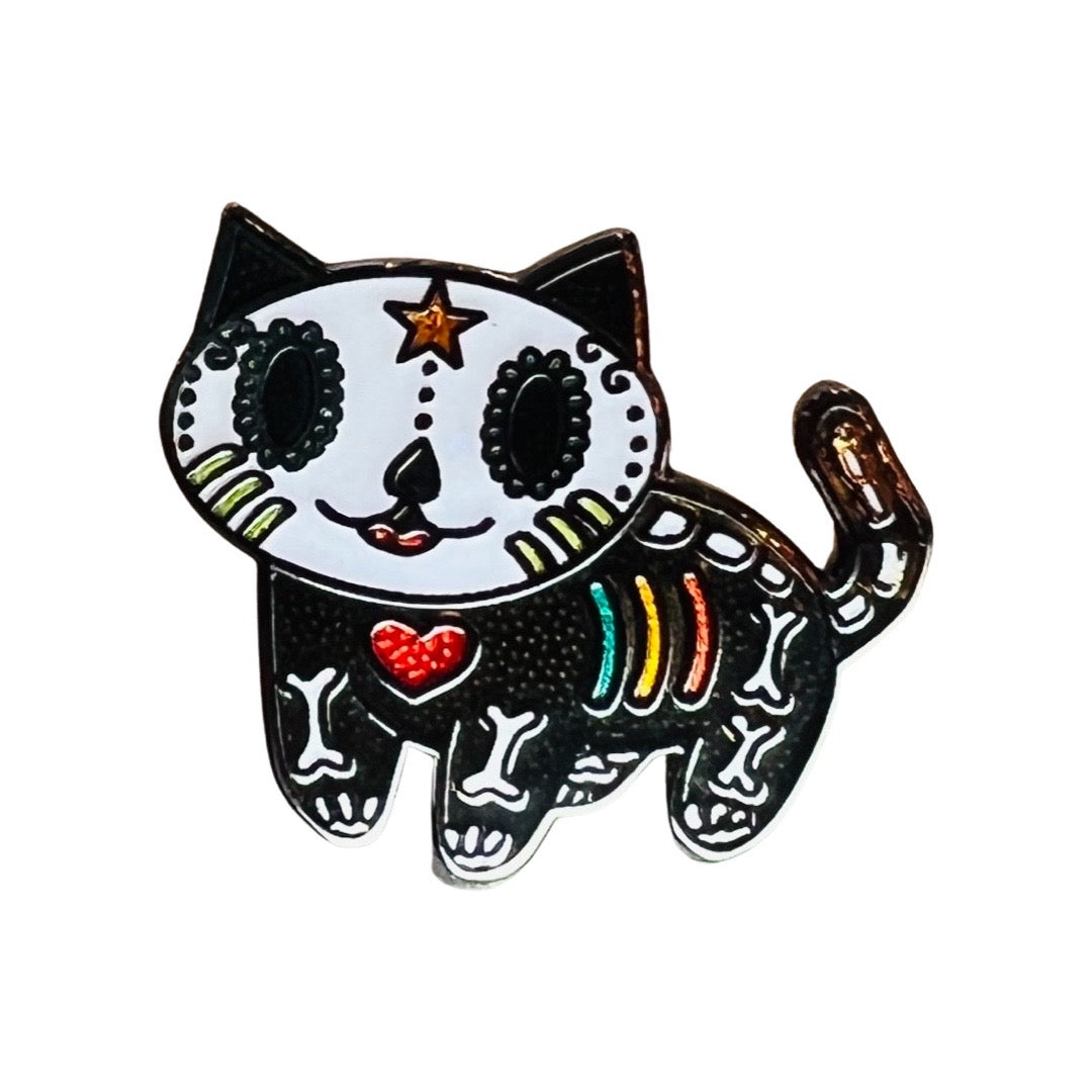 Black enamel pin featuring a skeleton cat with a red heart