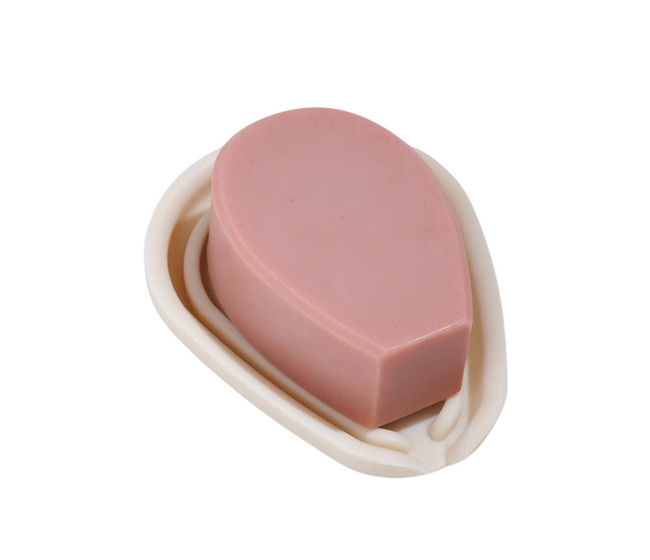 Pink bar of soap on top of a beige soap tray.