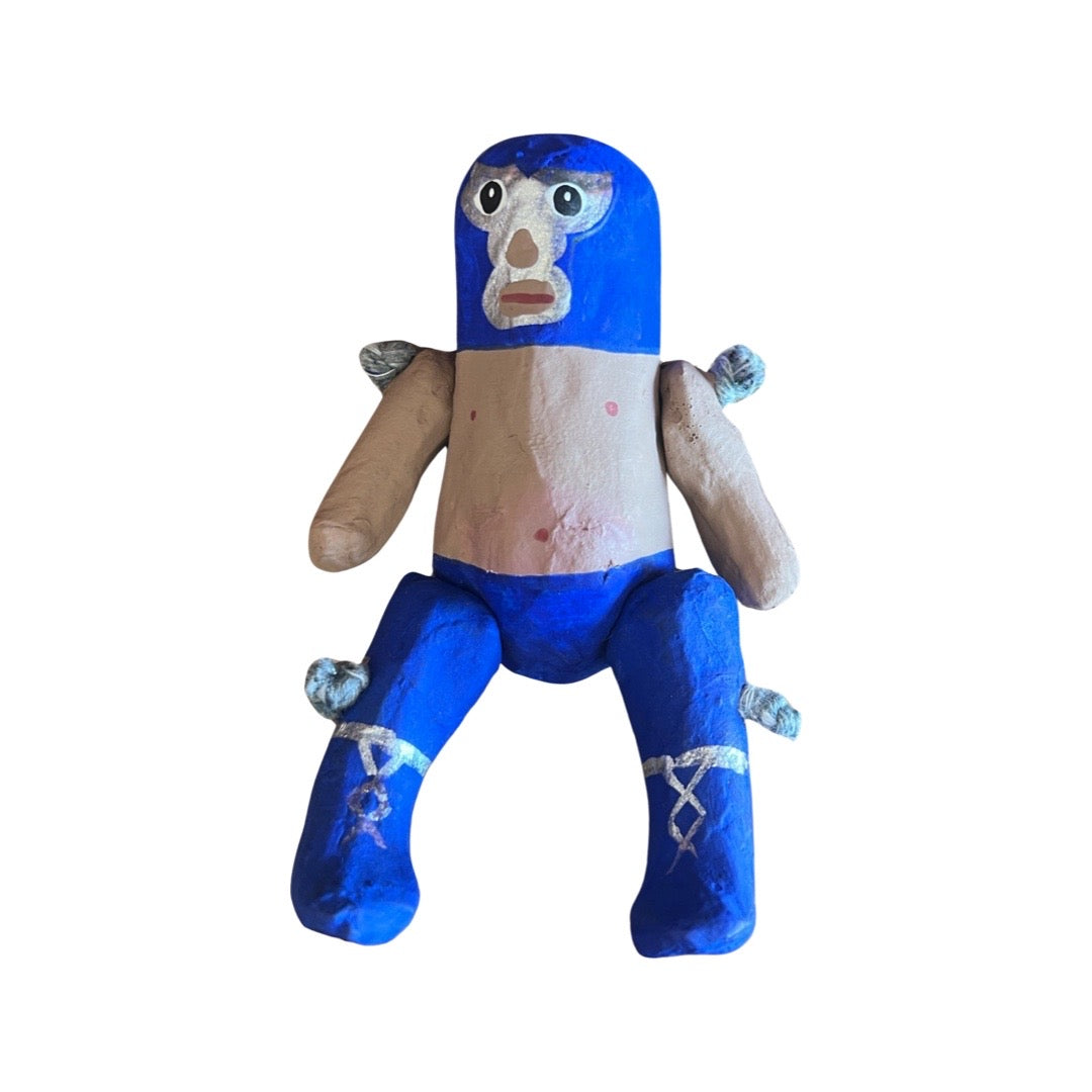 Paper mache luchador with blue leggings and mask