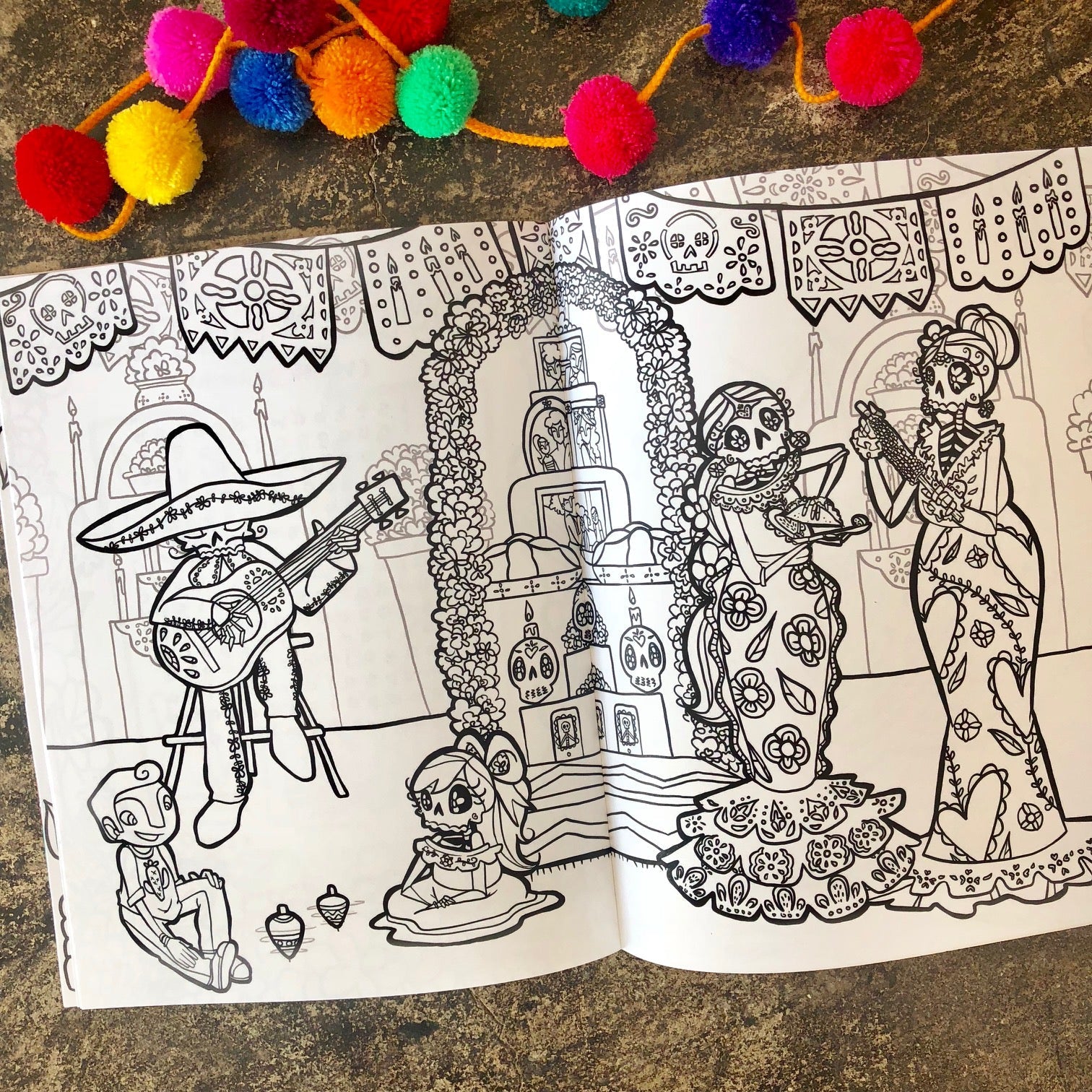Photo of spread inside the Dia De Los Muertos Coloring Book