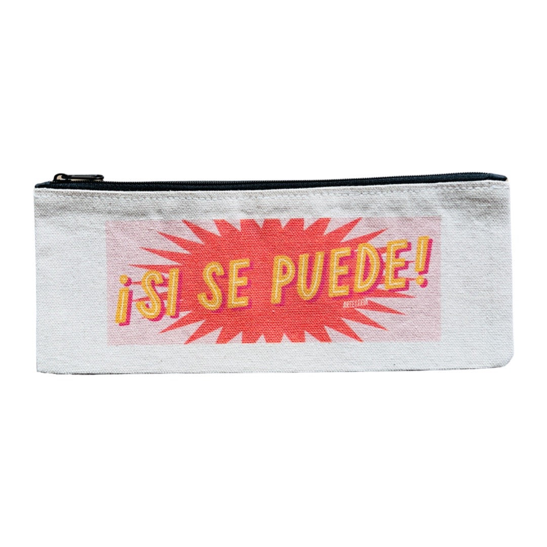 Canvas pencil pouch with an image of the phrase Si se Puede in yellow and white lettering with a light pink and orange star burst background.