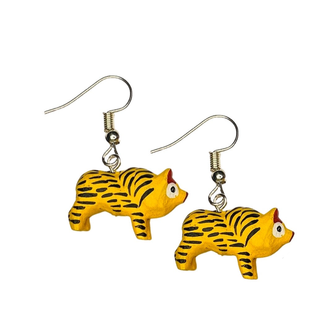 A set of alebrije pig earrings of various colors and design